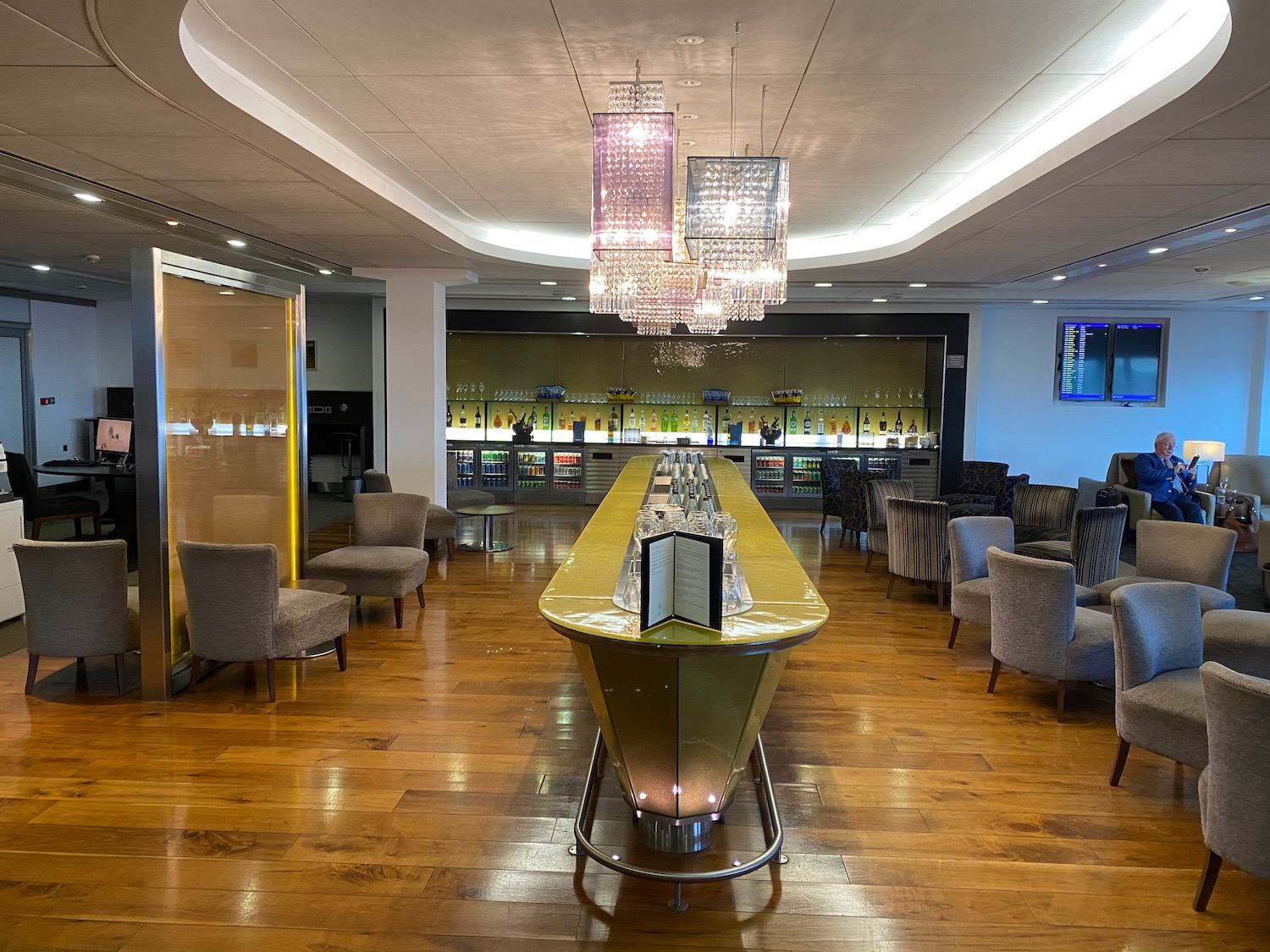 a bar with a long table and chairs