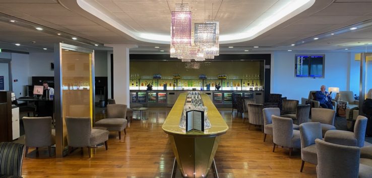 a bar in a room with chairs and a table