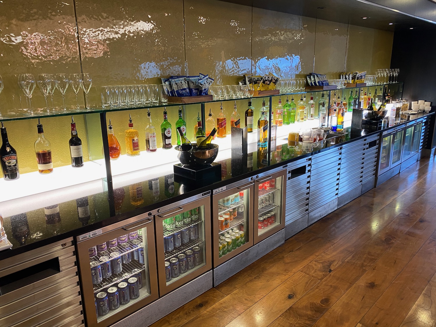 a bar with bottles and glasses on top