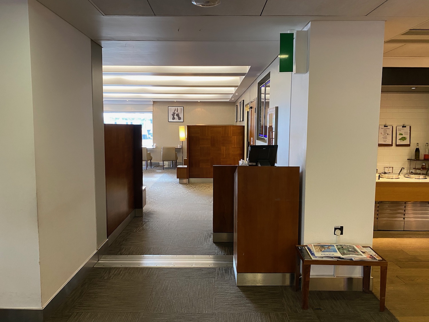 a hallway with a computer and a table