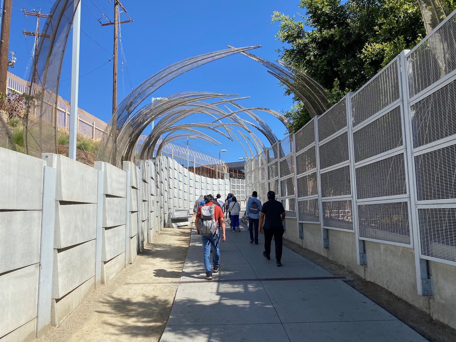 a group of people walking down a walkway