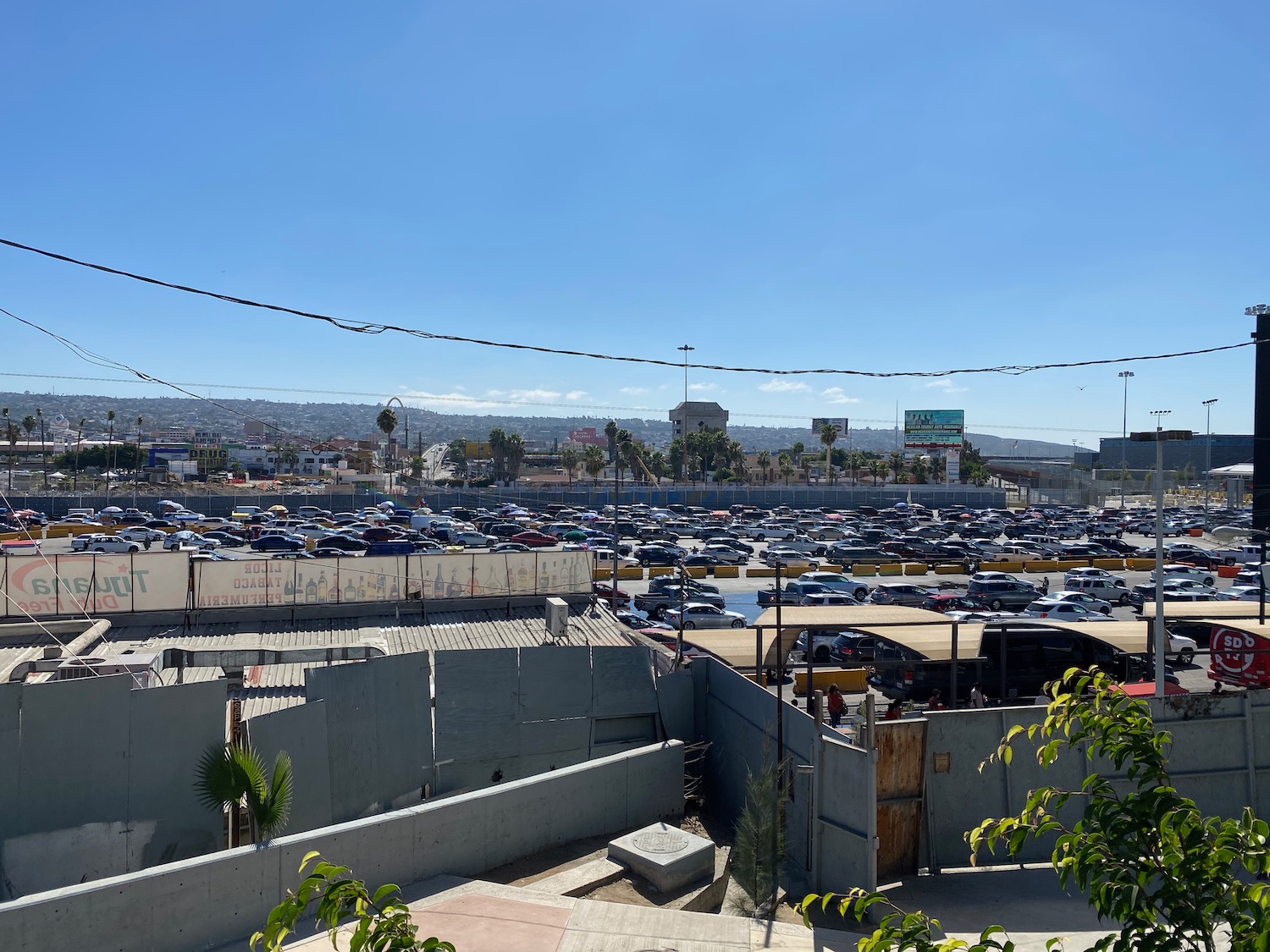 a parking lot with cars and buildings in the background