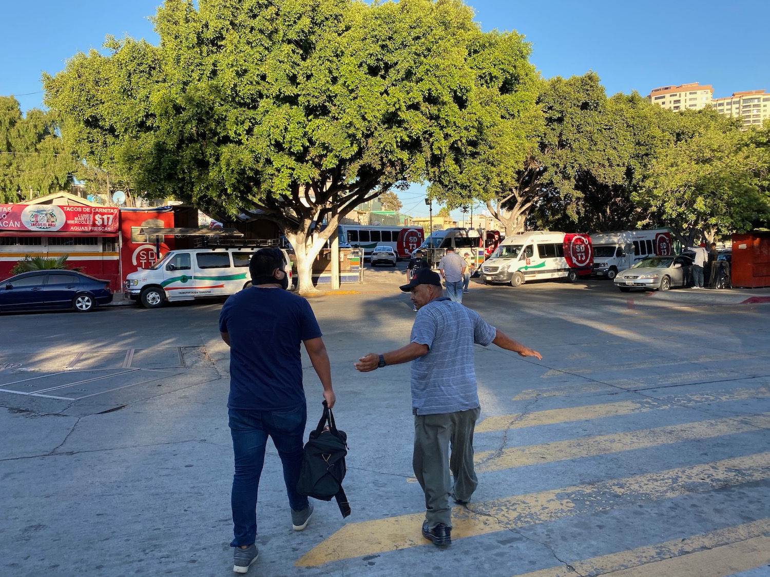 two men crossing a street