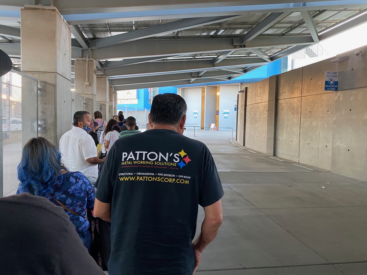 a group of people walking down a walkway