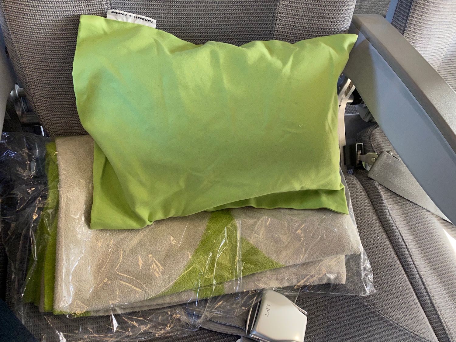 a green pillow on a chair