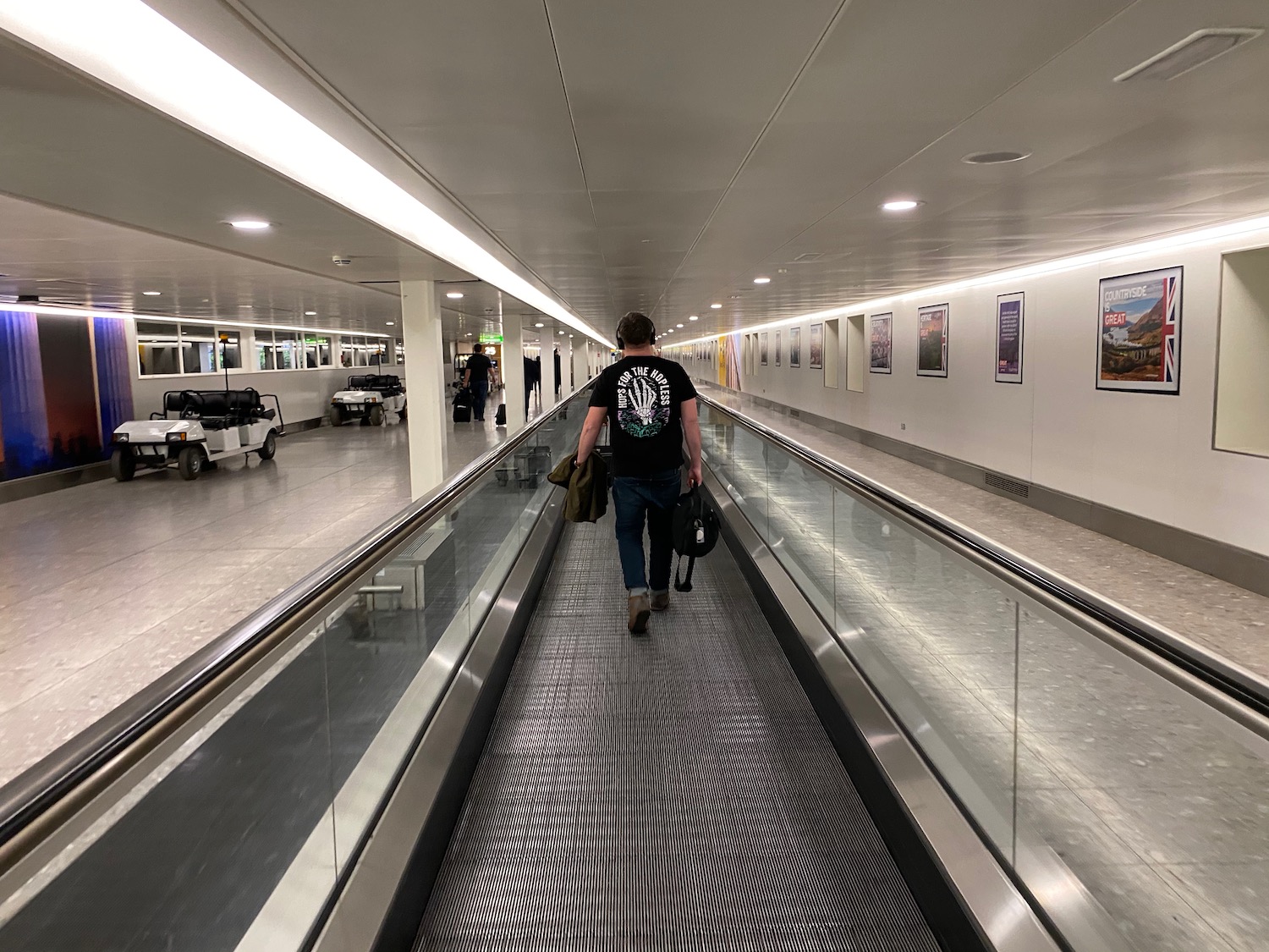 a man walking down a moving walkway