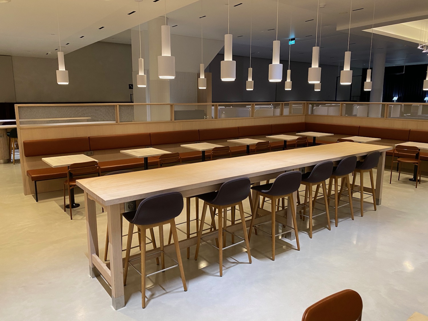 a long table with chairs and a bench in a restaurant