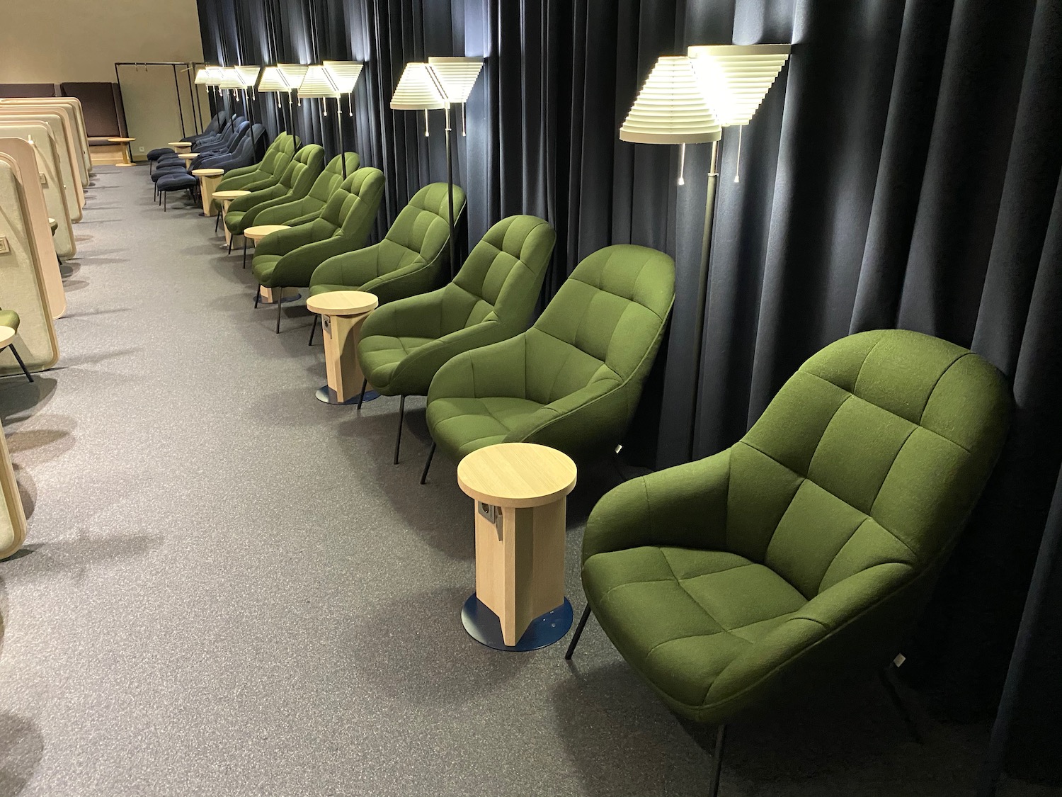 a row of green chairs and a table