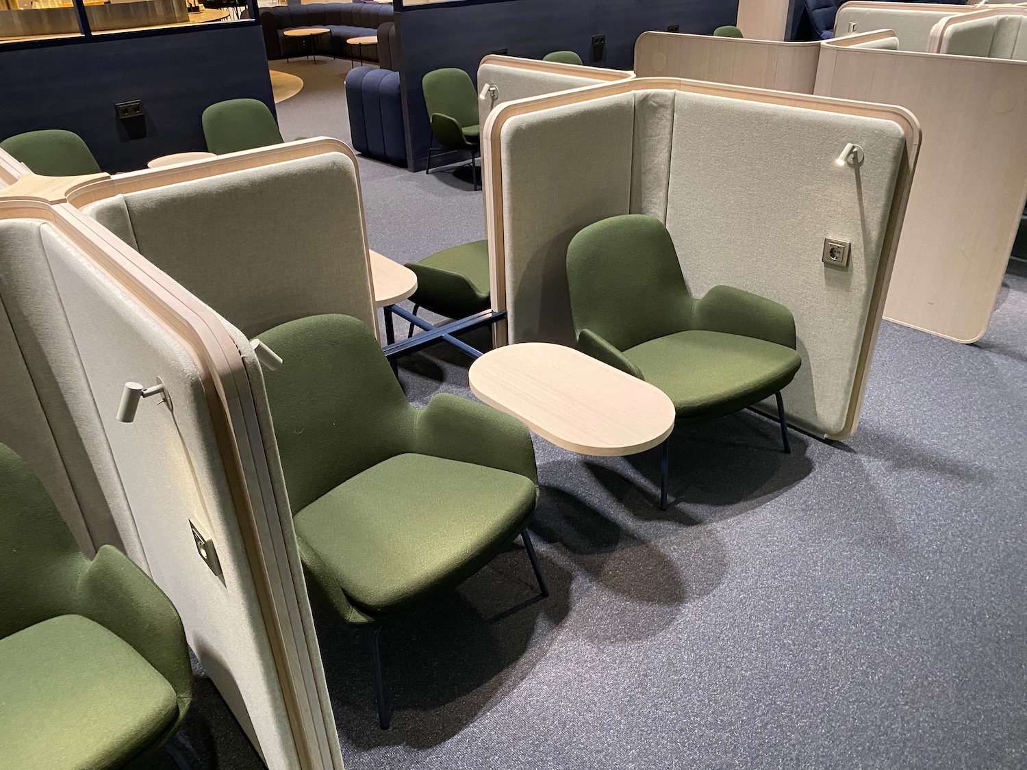 a room with green chairs and a table