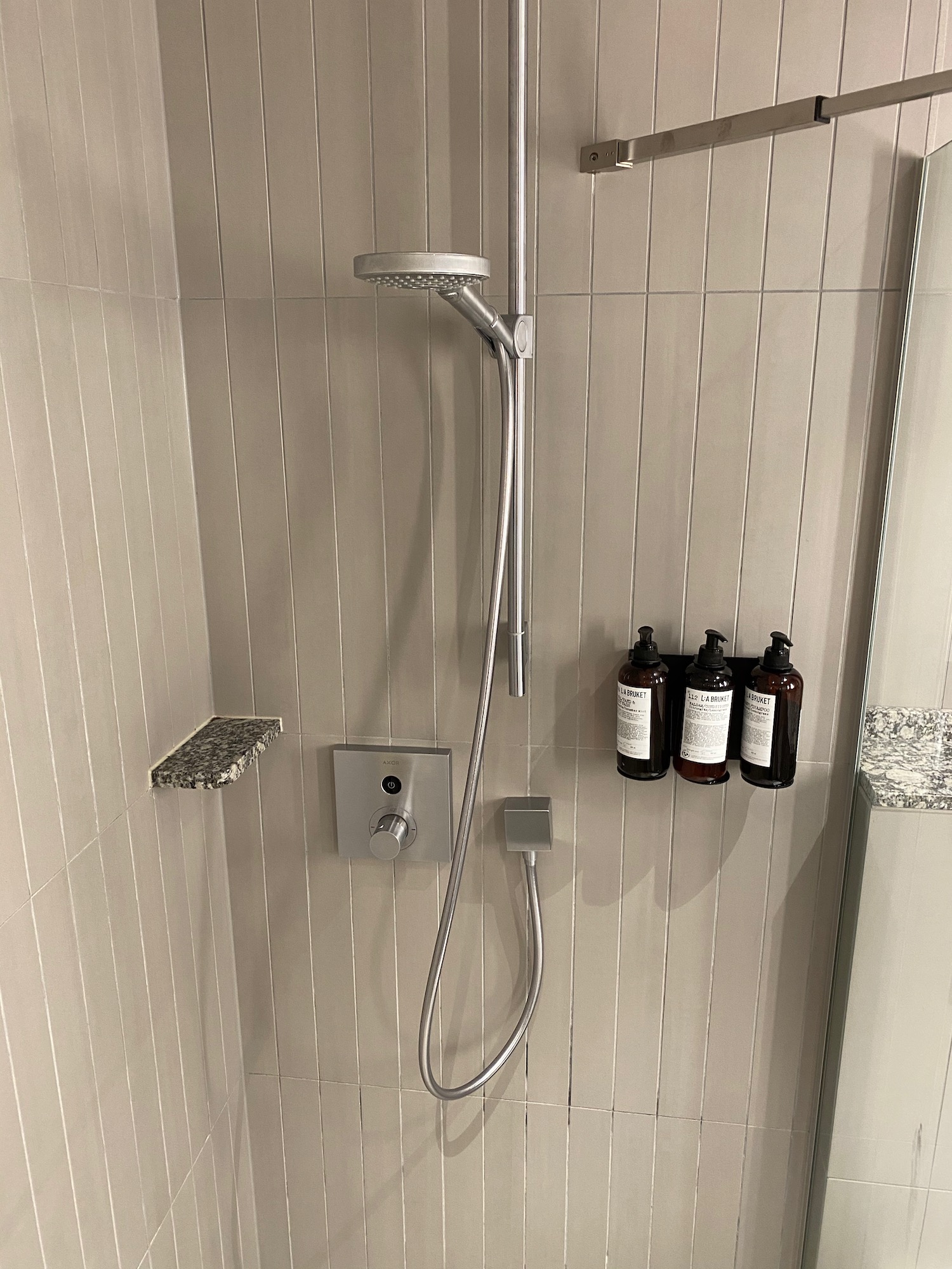 a shower head and bottles on the wall
