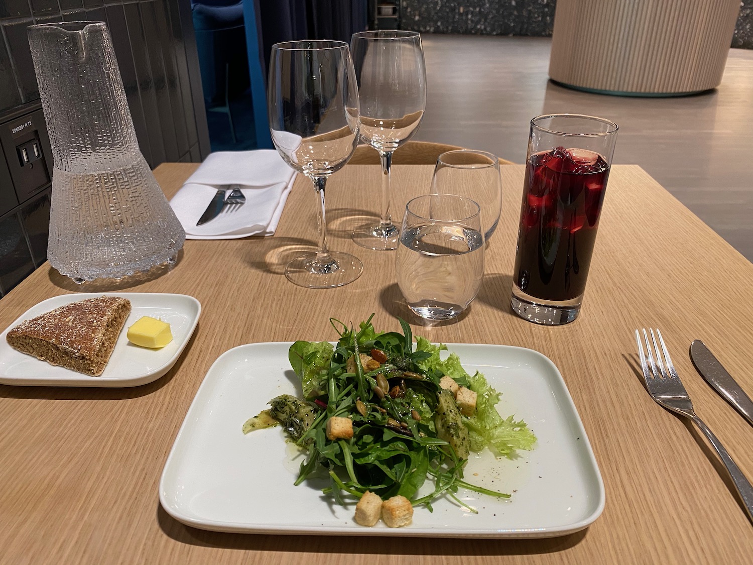 a plate of salad and glasses on a table