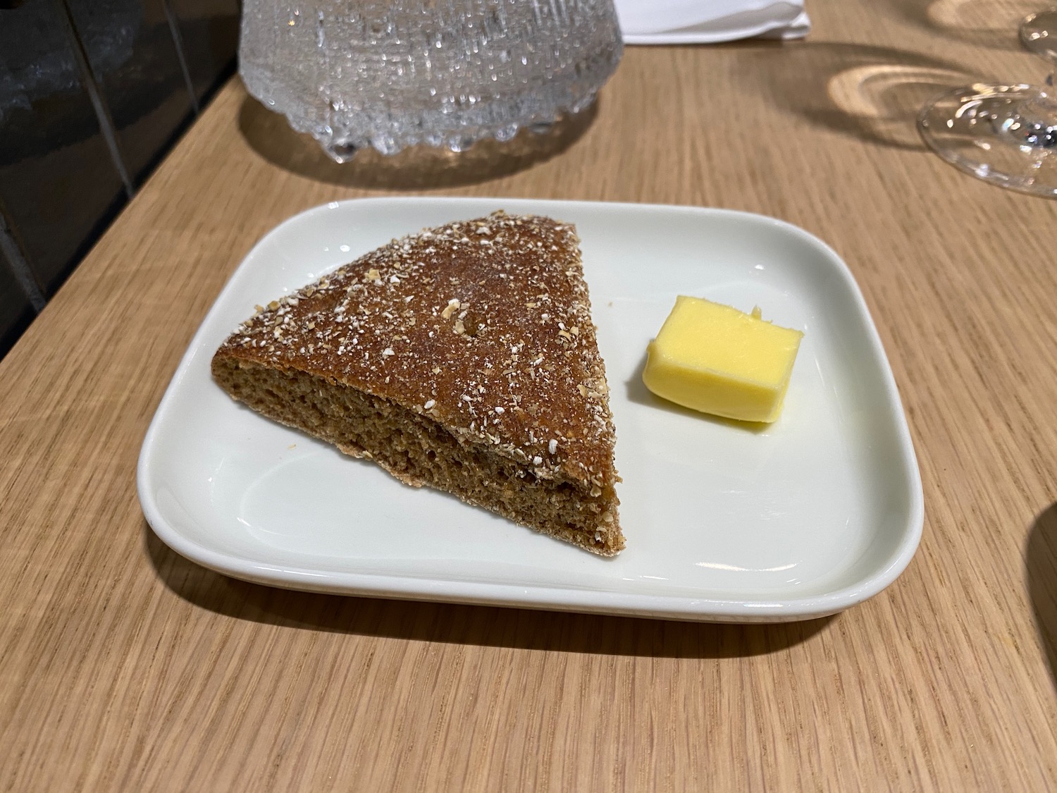 a piece of bread on a plate with butter