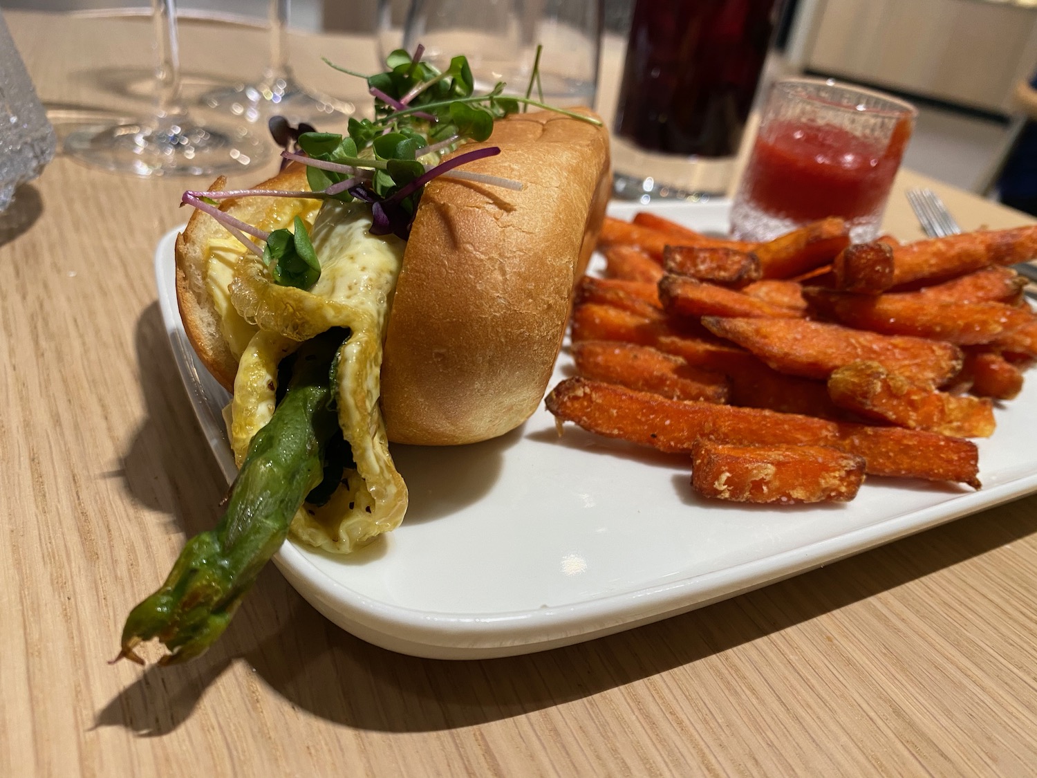 a sandwich with asparagus and fries on a plate