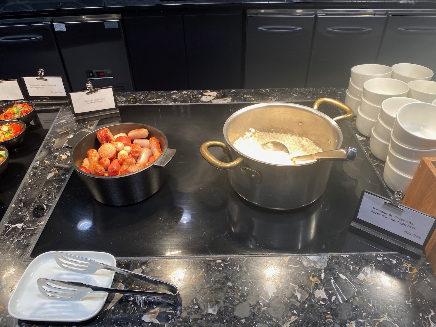 a group of pots and bowls of food on a counter