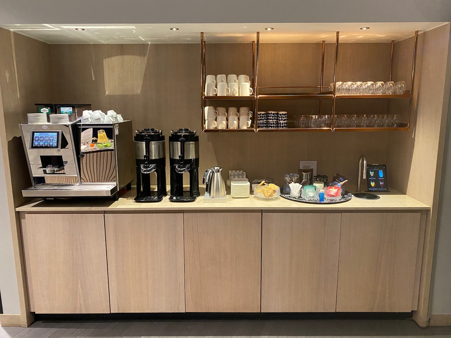 a coffee machine and cups on a counter