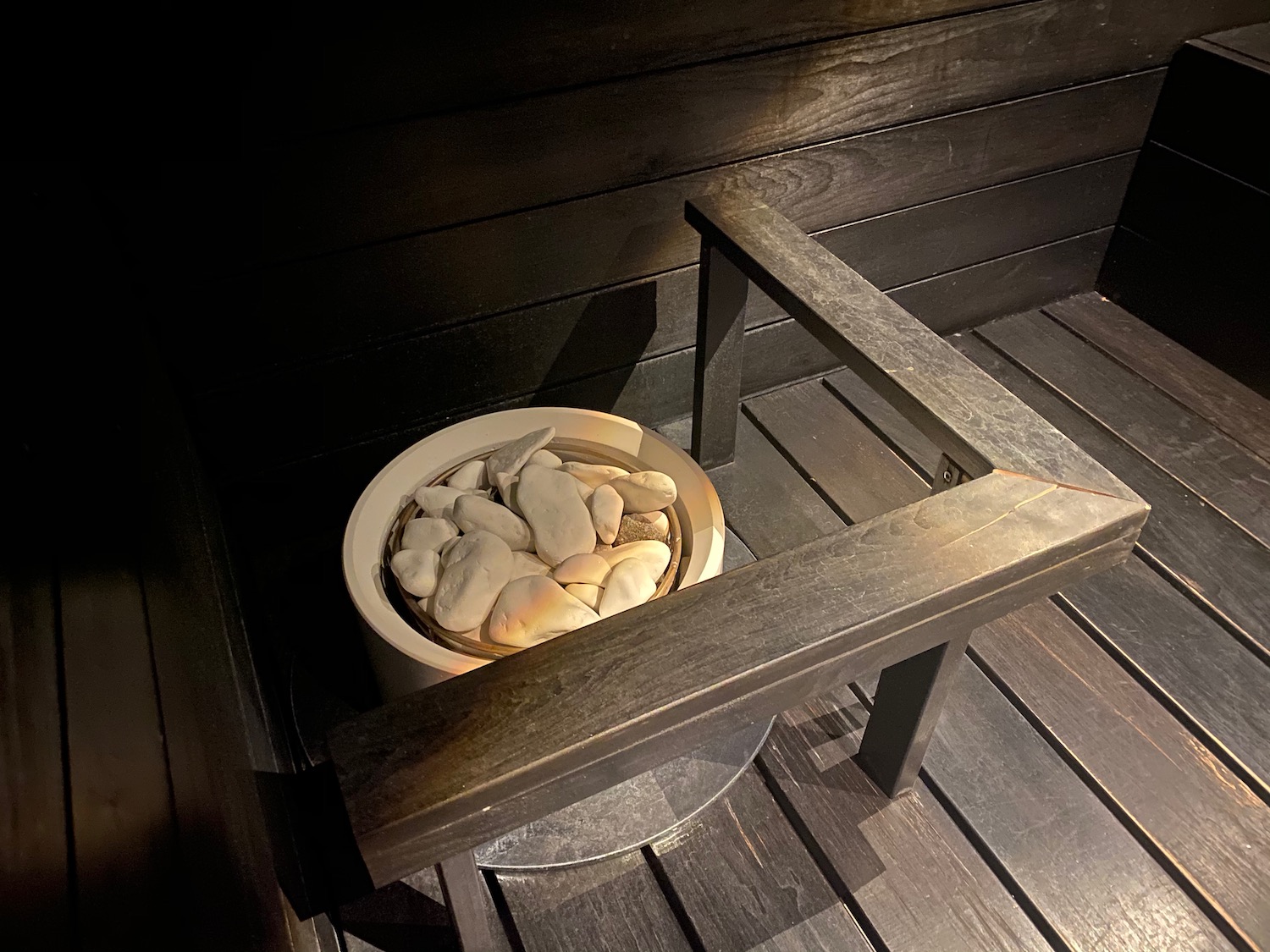 a bowl of rocks in a wooden table