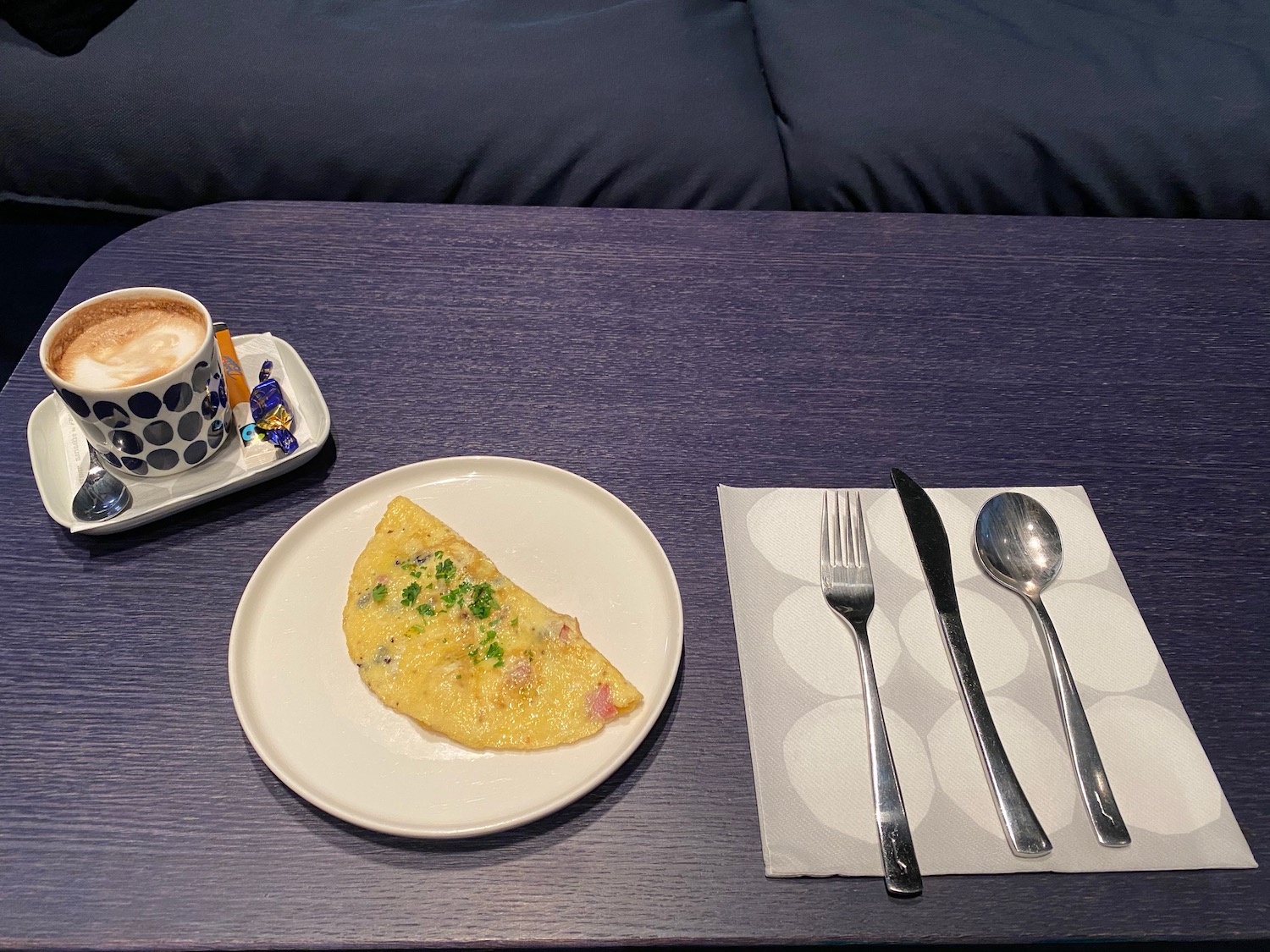 a plate of food and a cup of coffee on a table