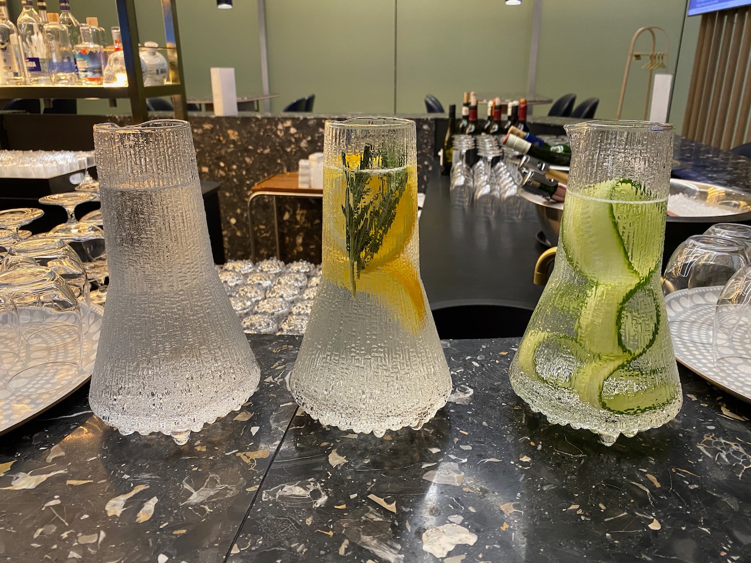 a group of vases with water and lemons