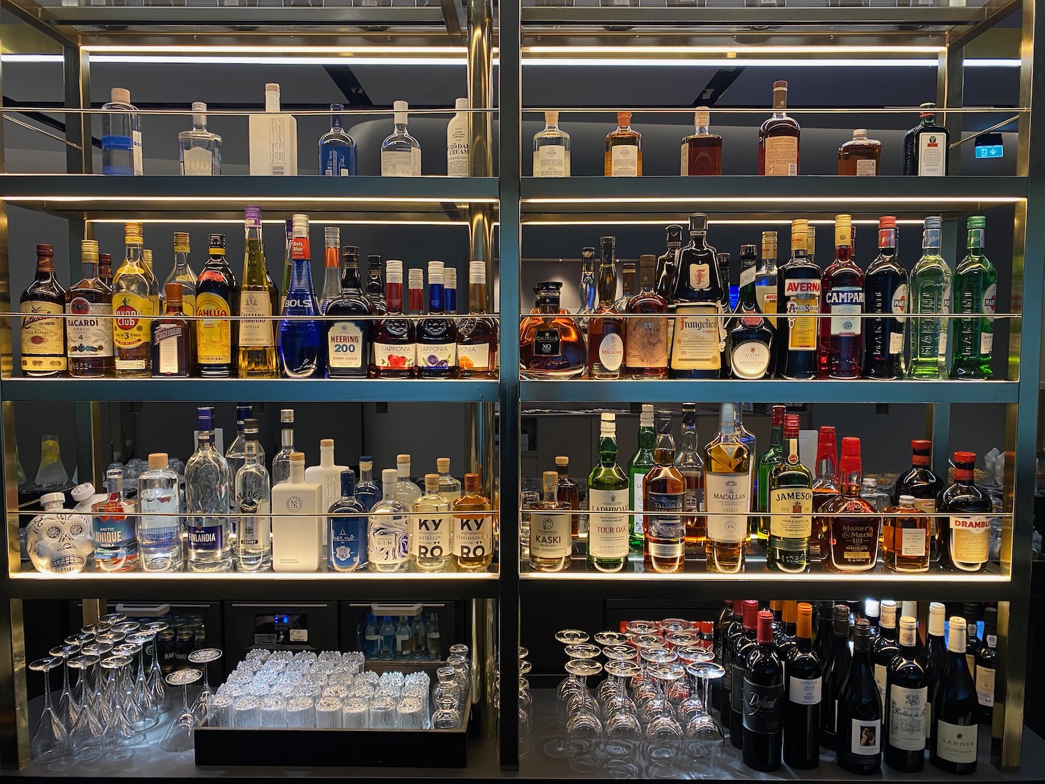 a shelf with bottles and glasses