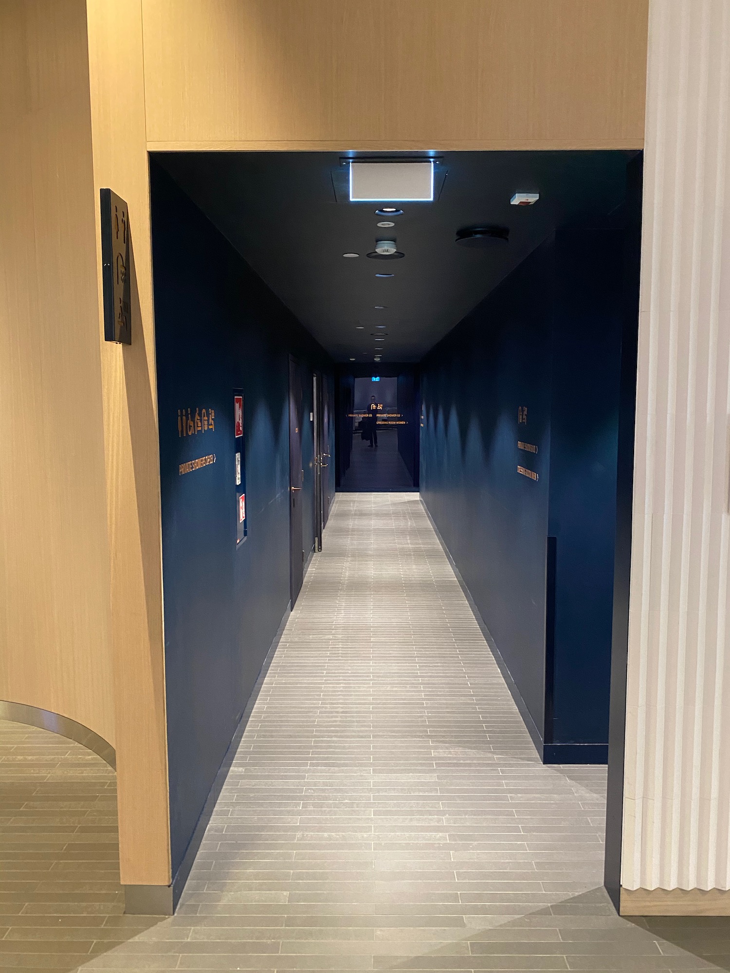 a hallway with blue walls and a wood floor