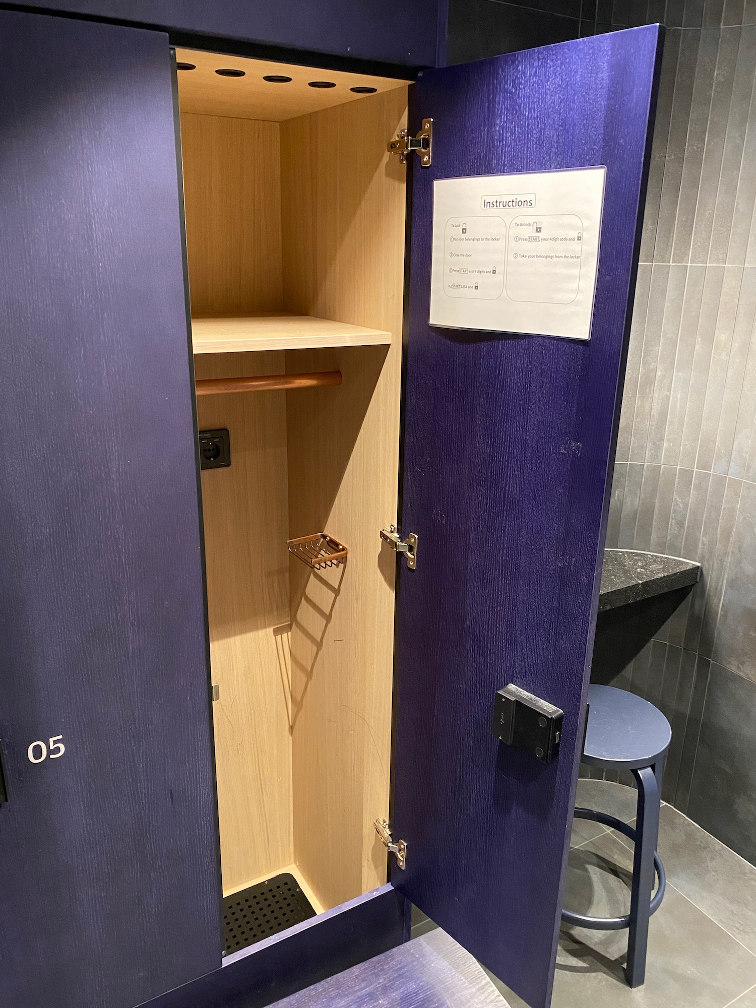 a blue locker with a ladder and a stool