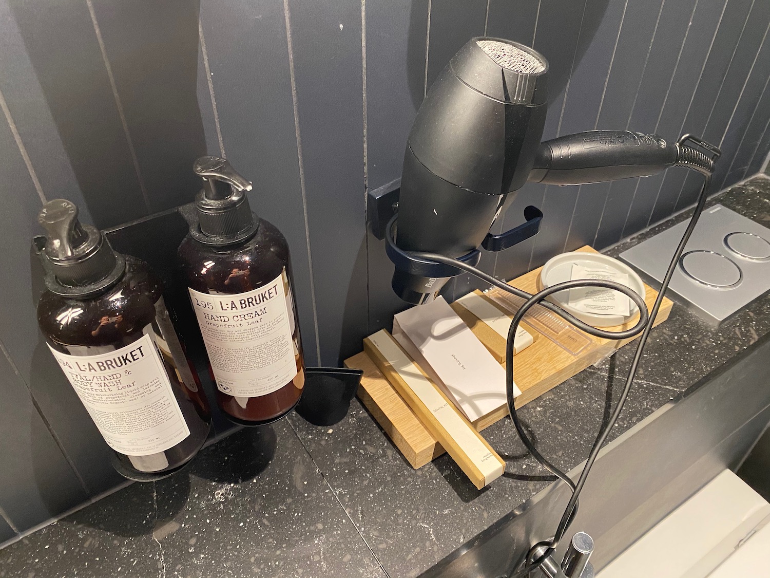 a hair dryer and shampoo on a counter