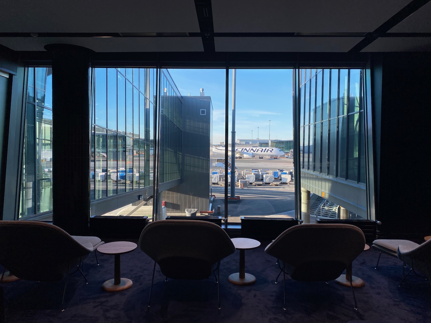 a room with chairs and tables and windows