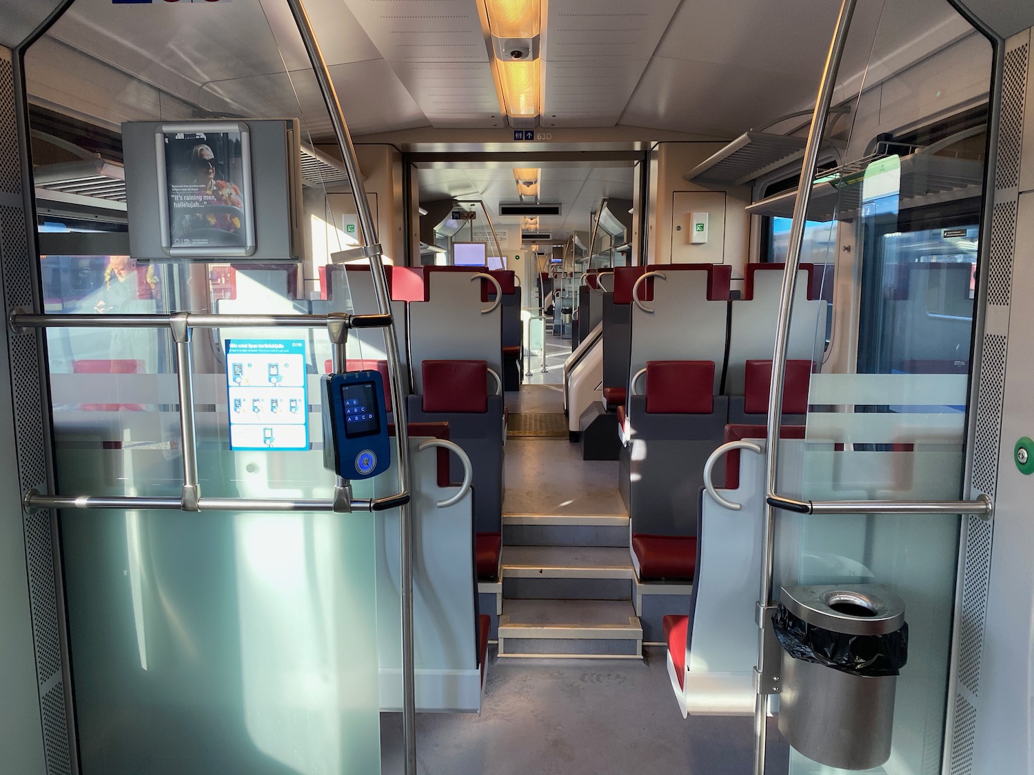 inside a train with seats and stairs