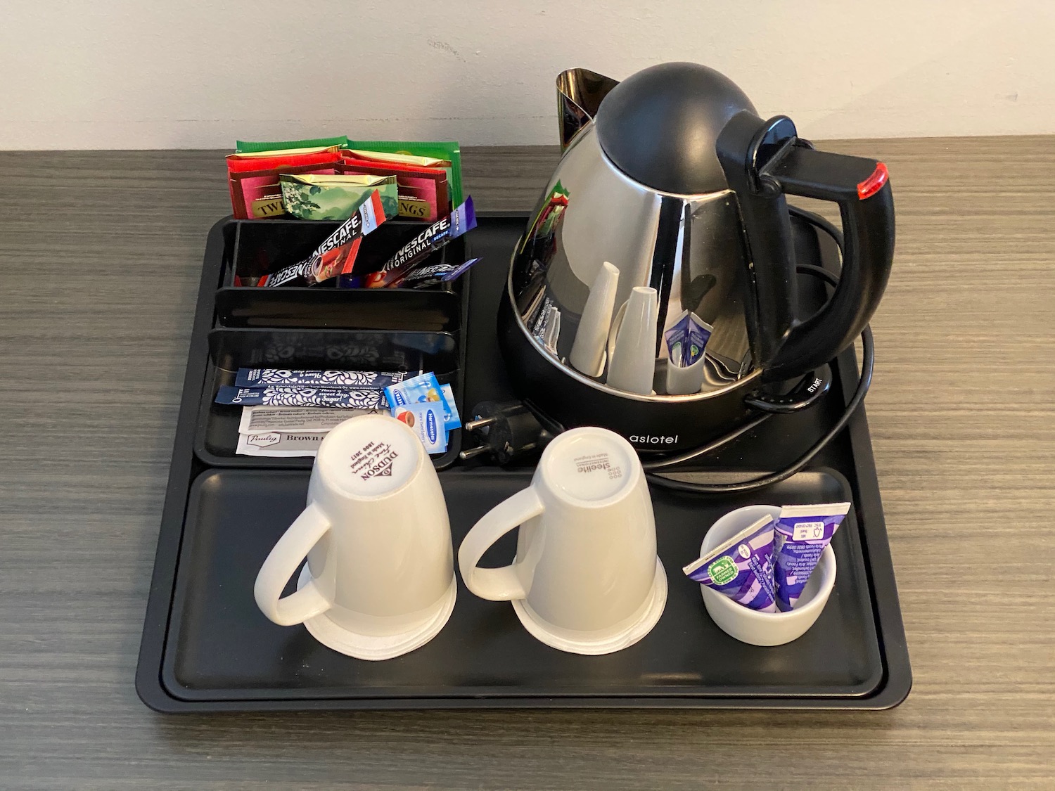 a tray with a coffee pot and cups on it