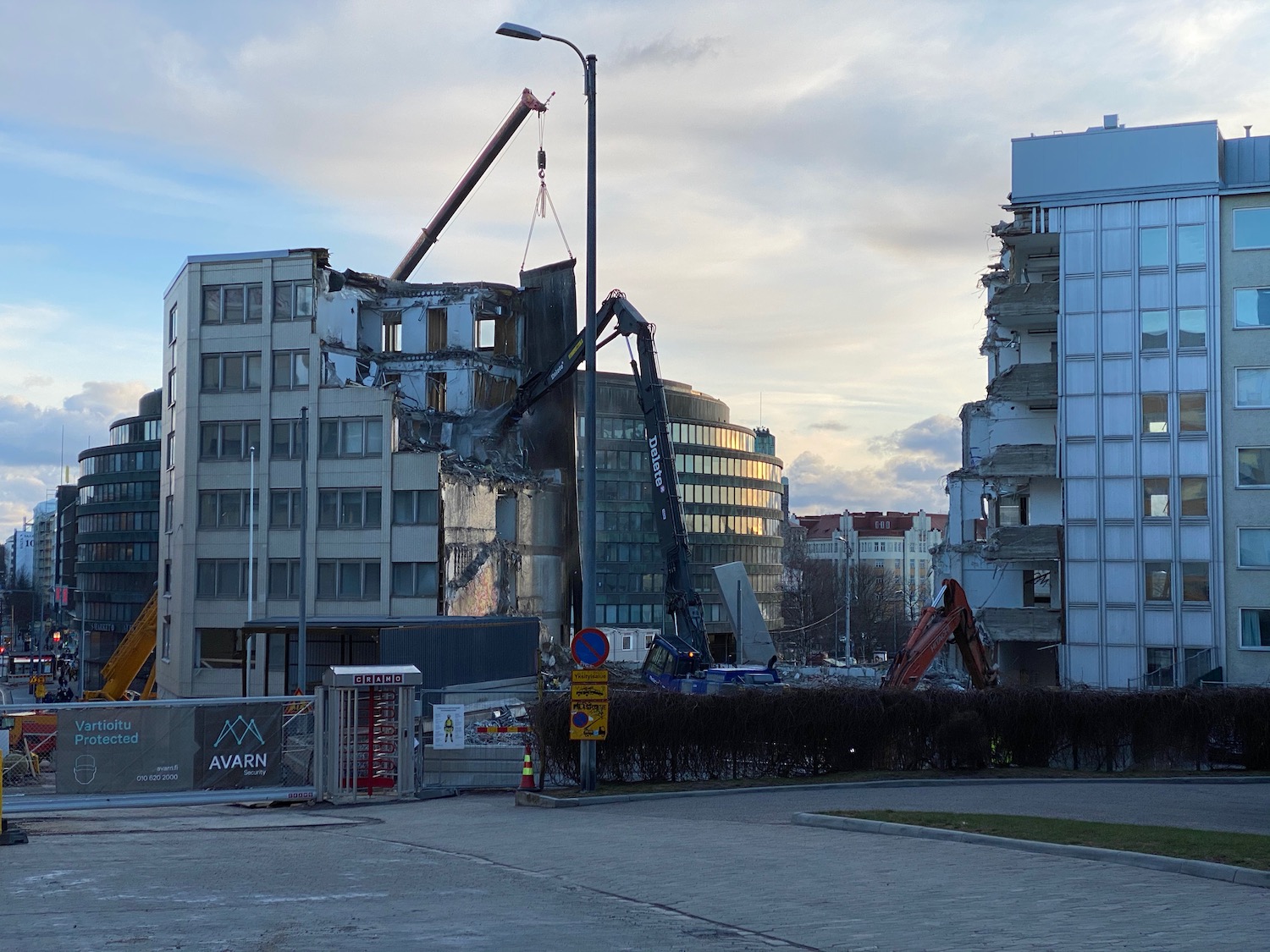 a crane lifting a building off of a building