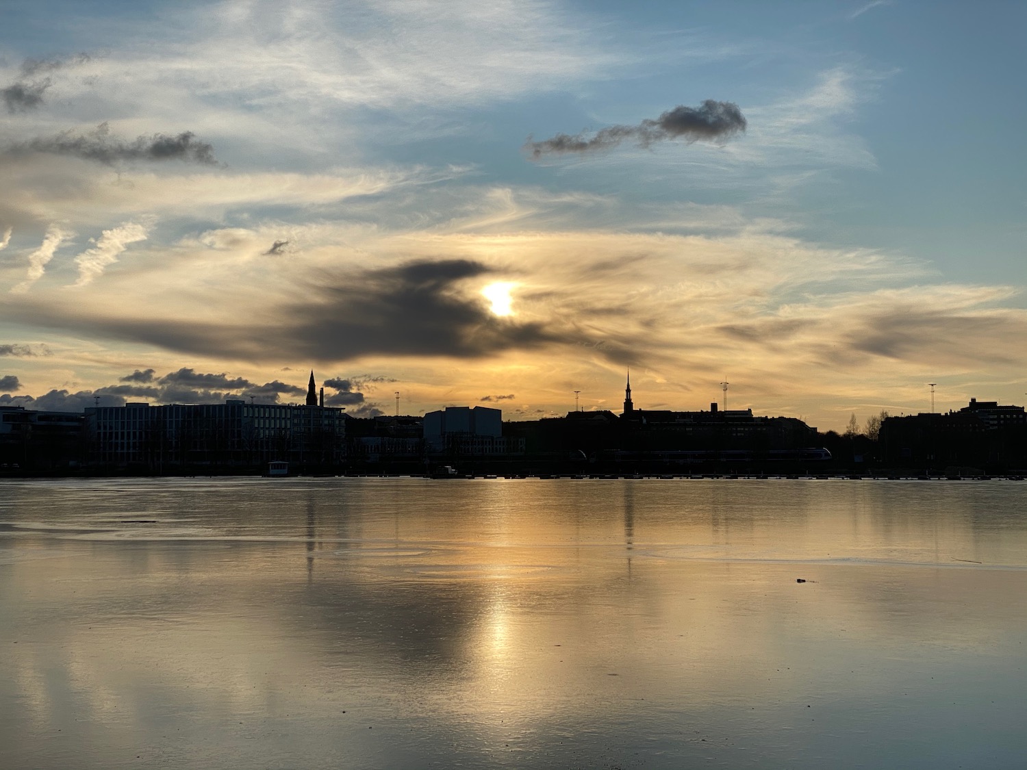 a body of water with buildings in the background