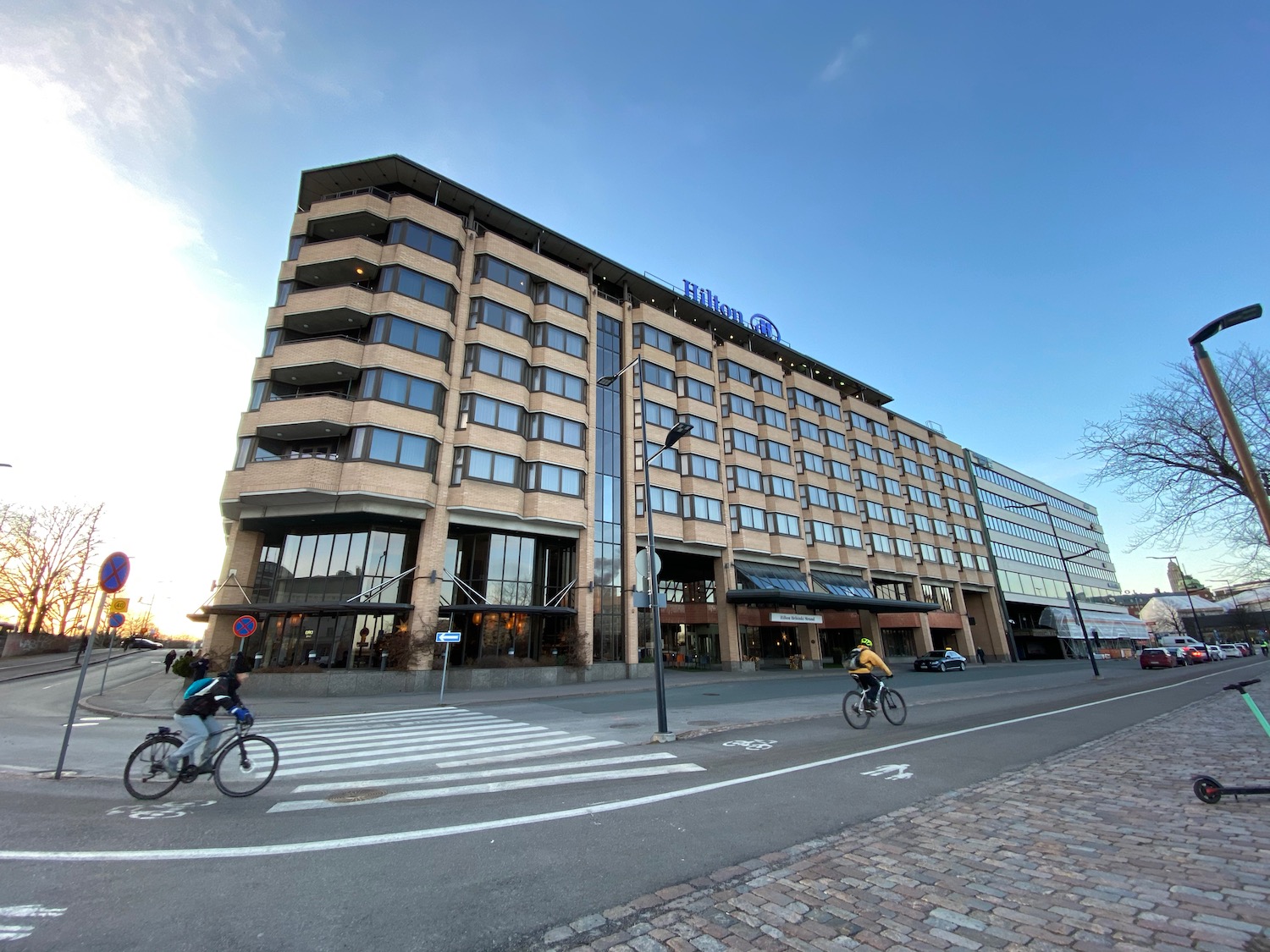 a building with windows and a couple of bikes on the street