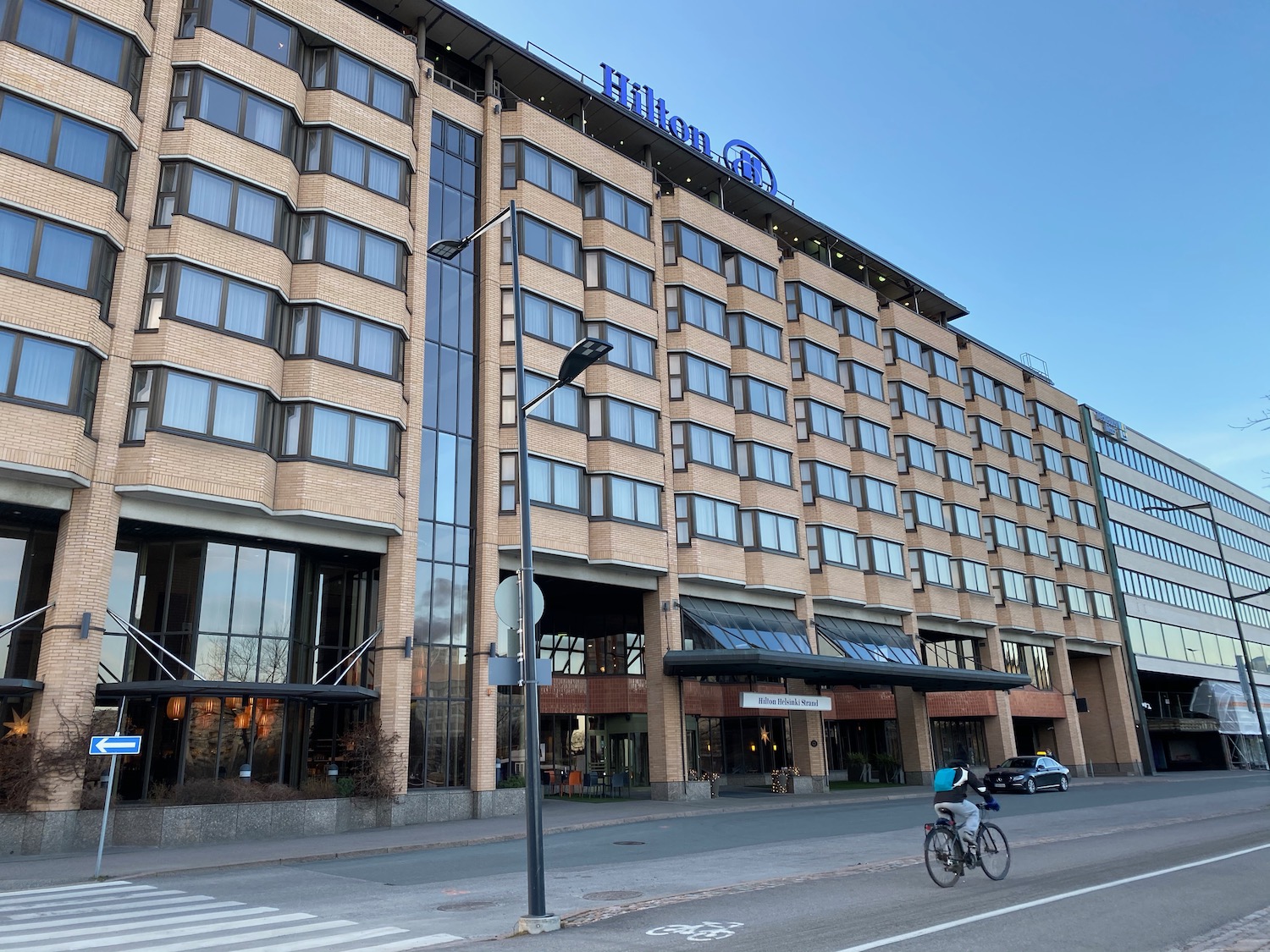 a building with windows and a bicycle on the street