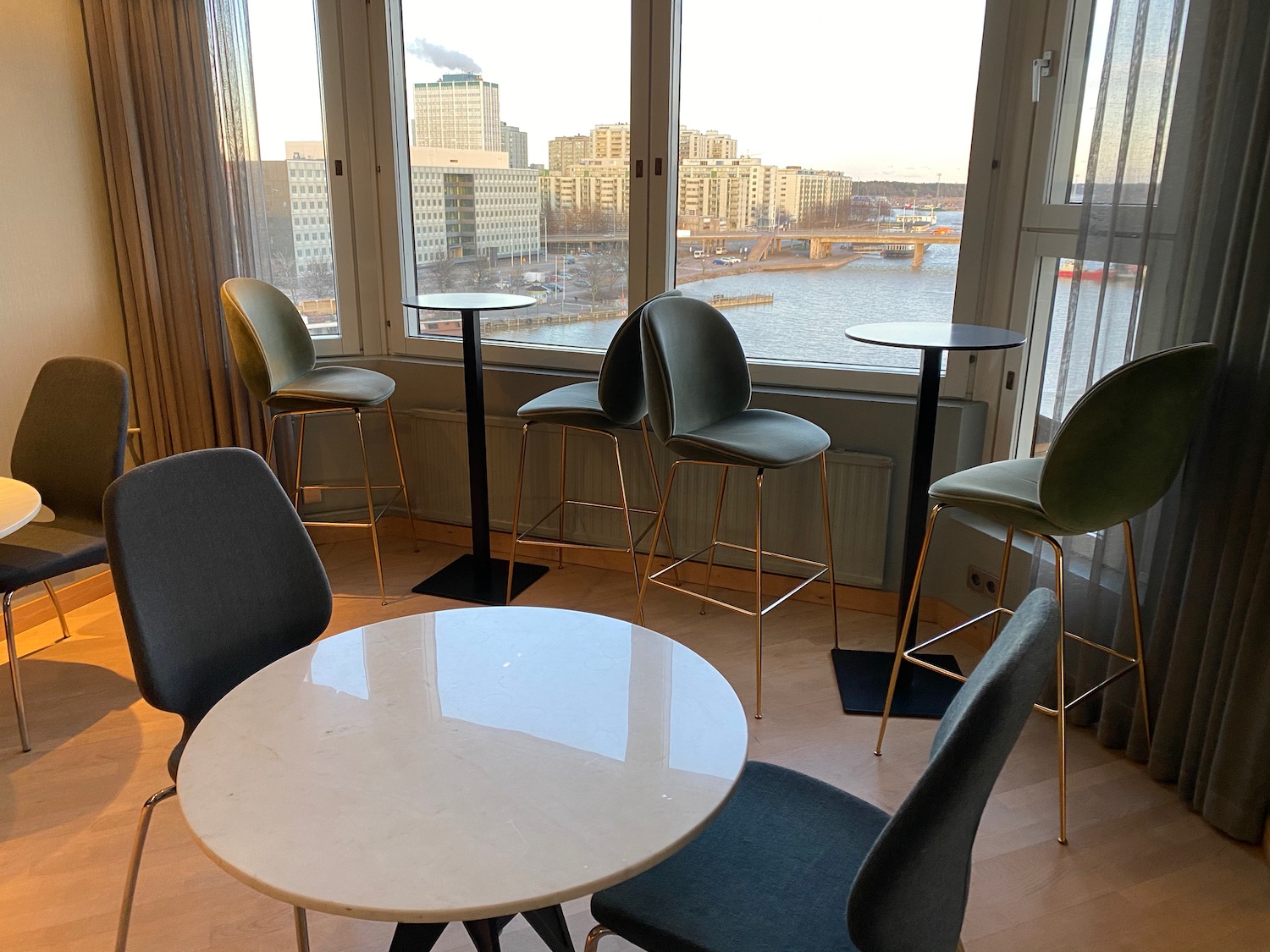 a room with a table and chairs and a view of a city