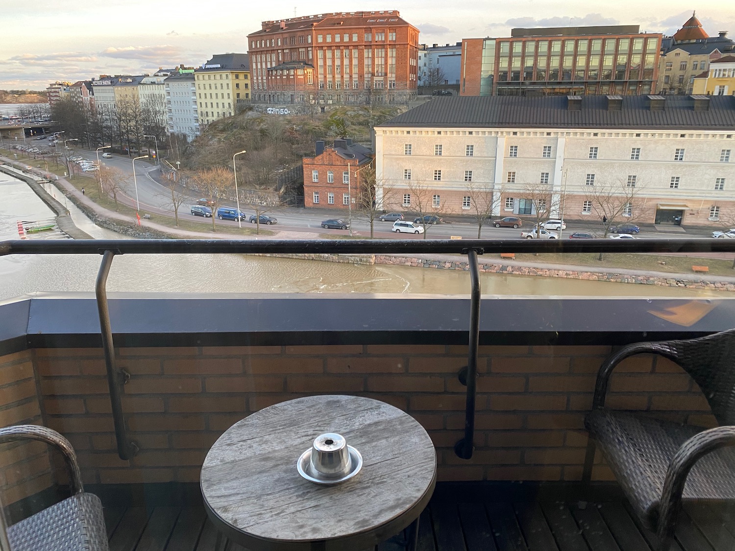 a table and chairs on a balcony overlooking a city