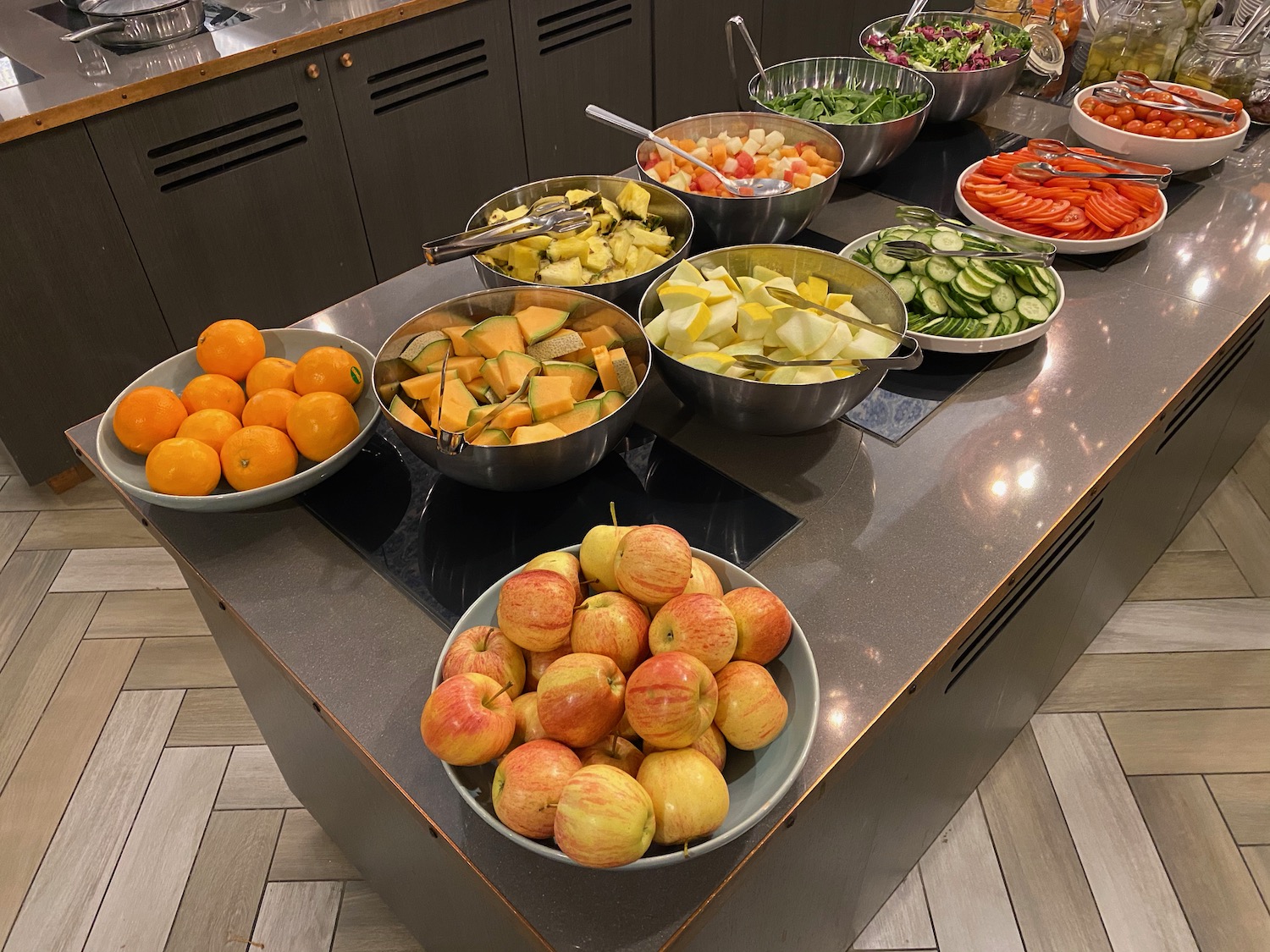 a group of bowls of fruit and vegetables on a counter