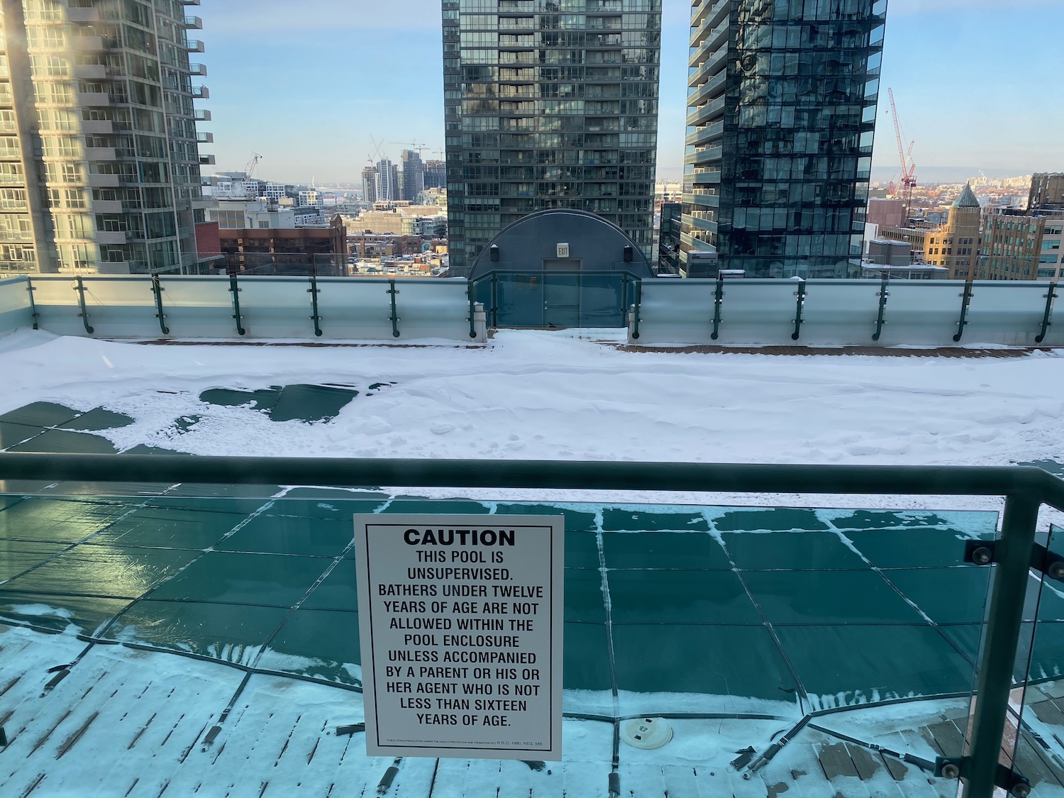 a sign on a roof with a city in the background