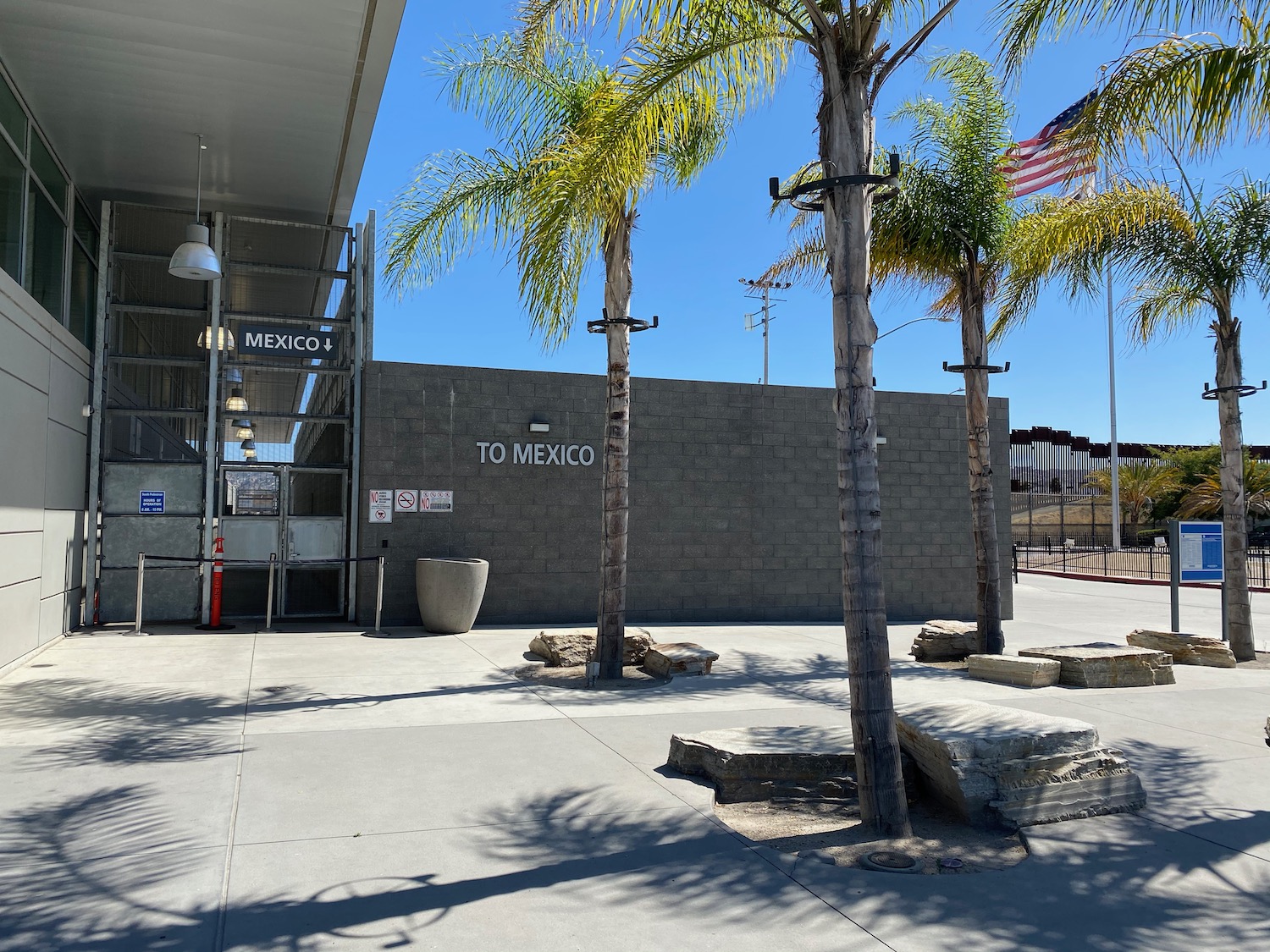 a building with palm trees and a sign