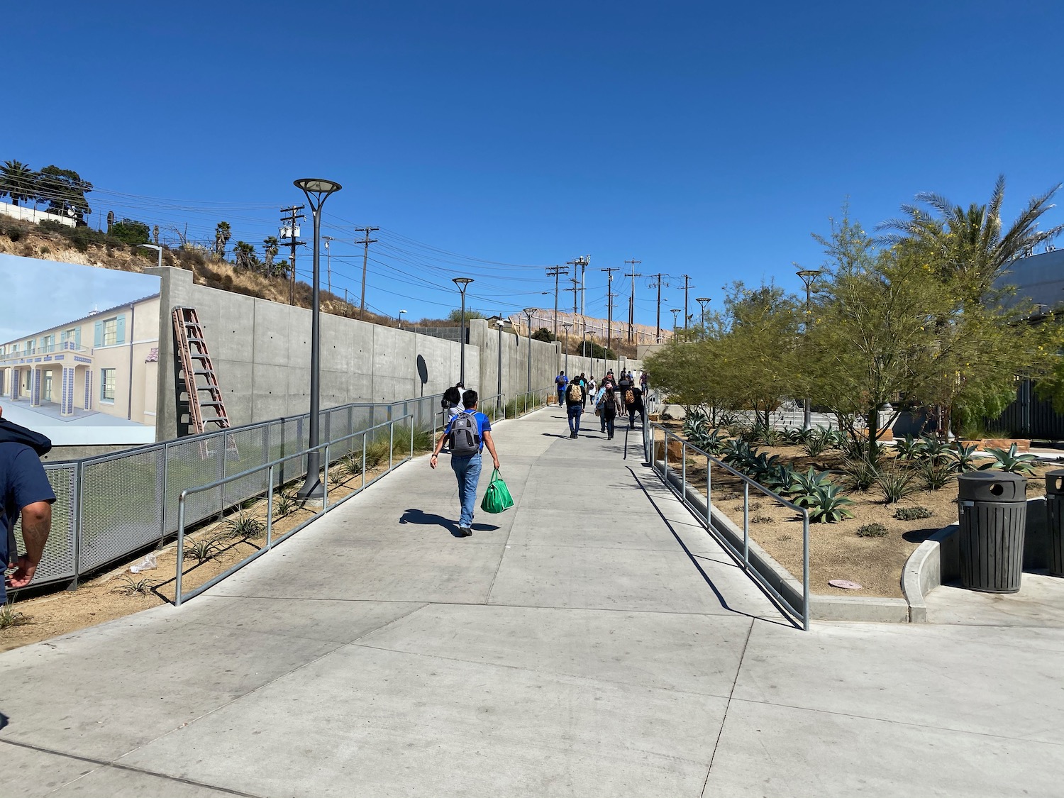 a group of people walking down a sidewalk