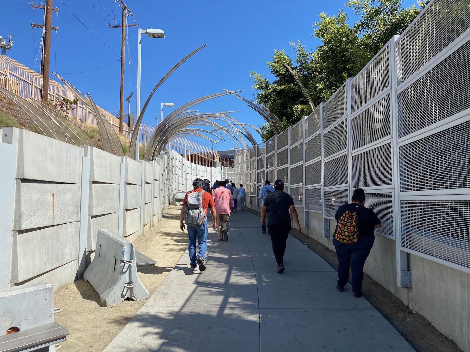 a group of people walking on a sidewalk