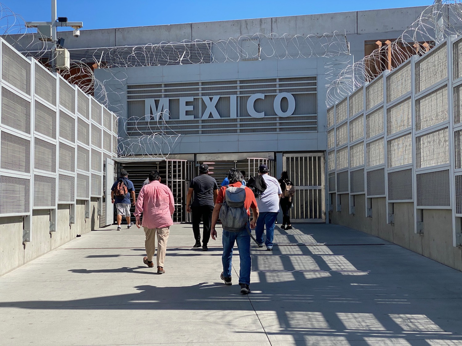 a group of people walking through a building