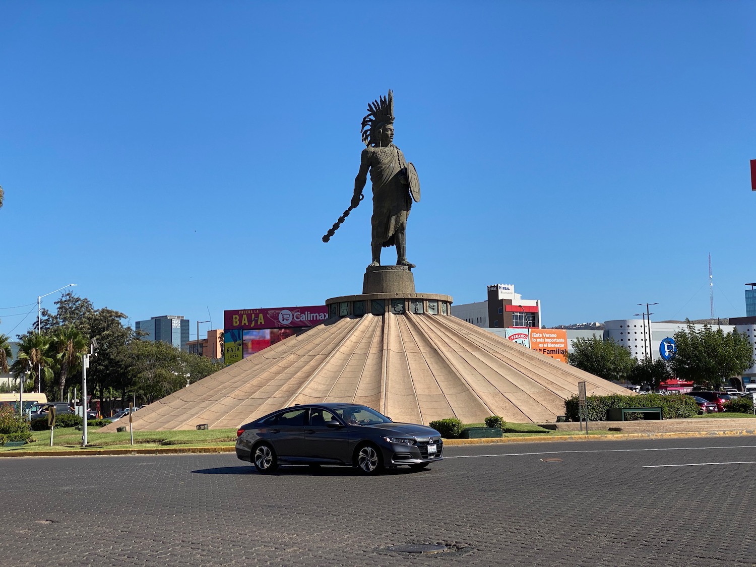 a car driving past a statue