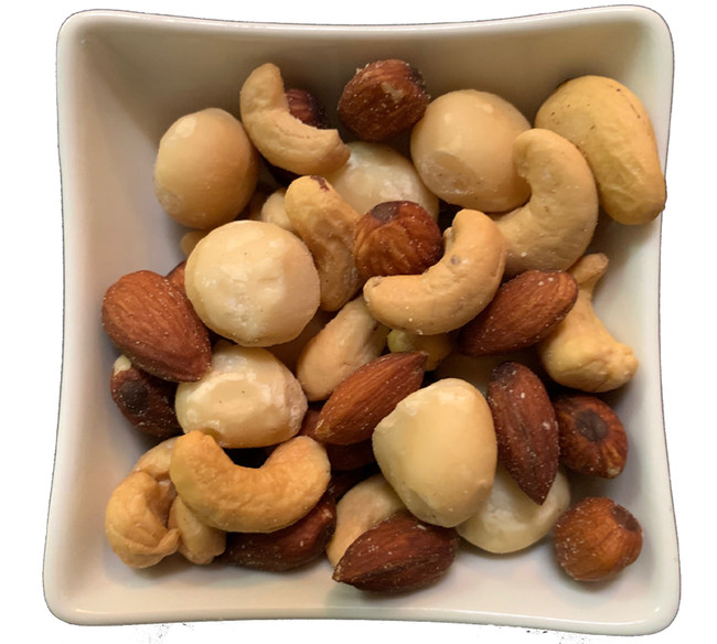 a bowl of nuts on a white surface