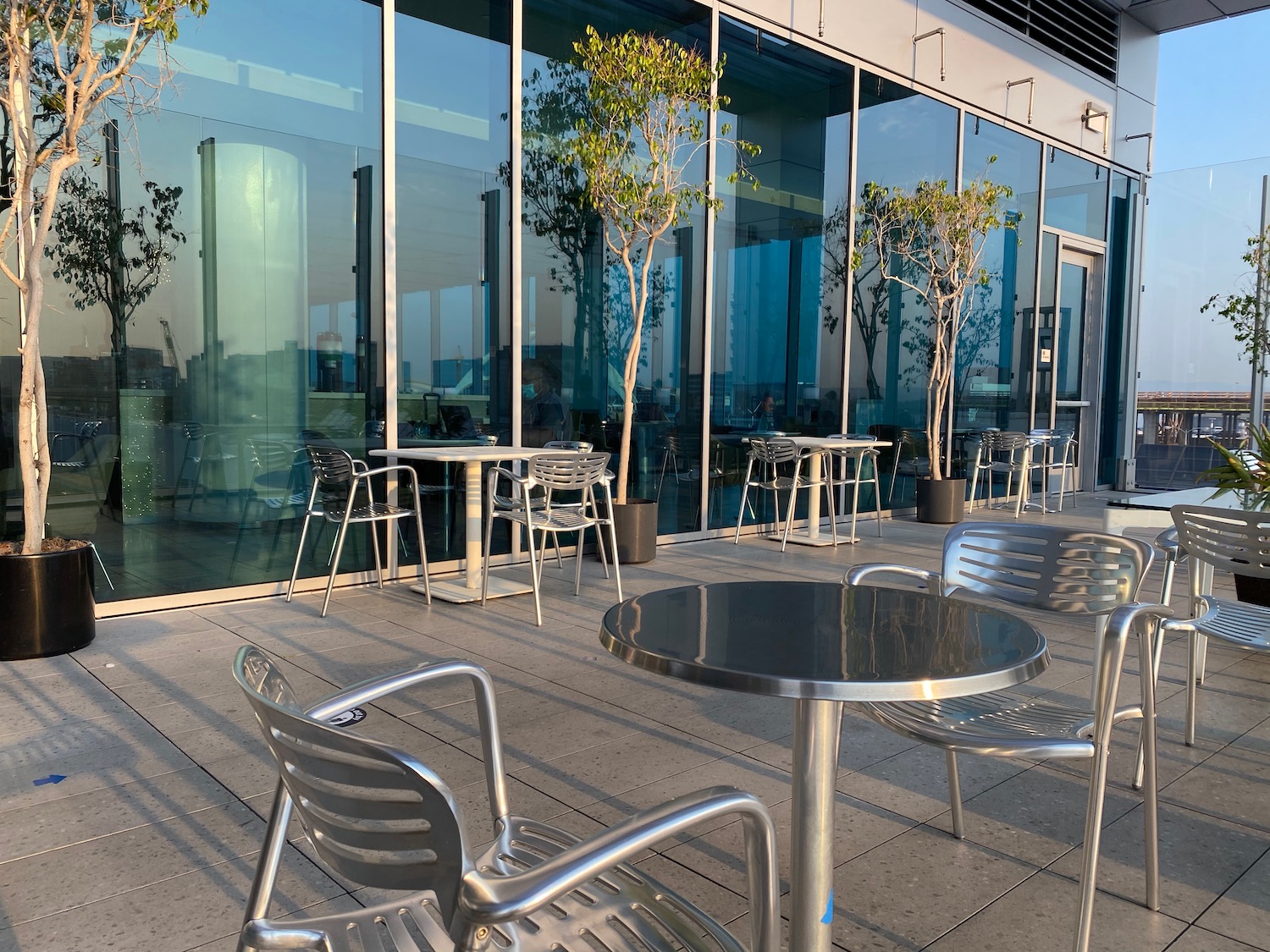 a glass building with tables and chairs