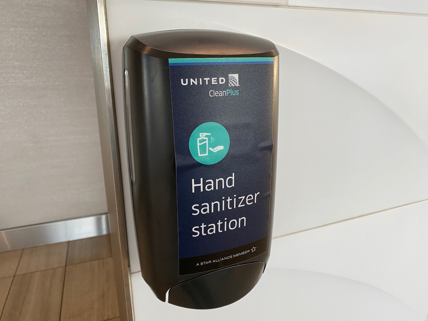 a hand sanitizer dispenser on a wall