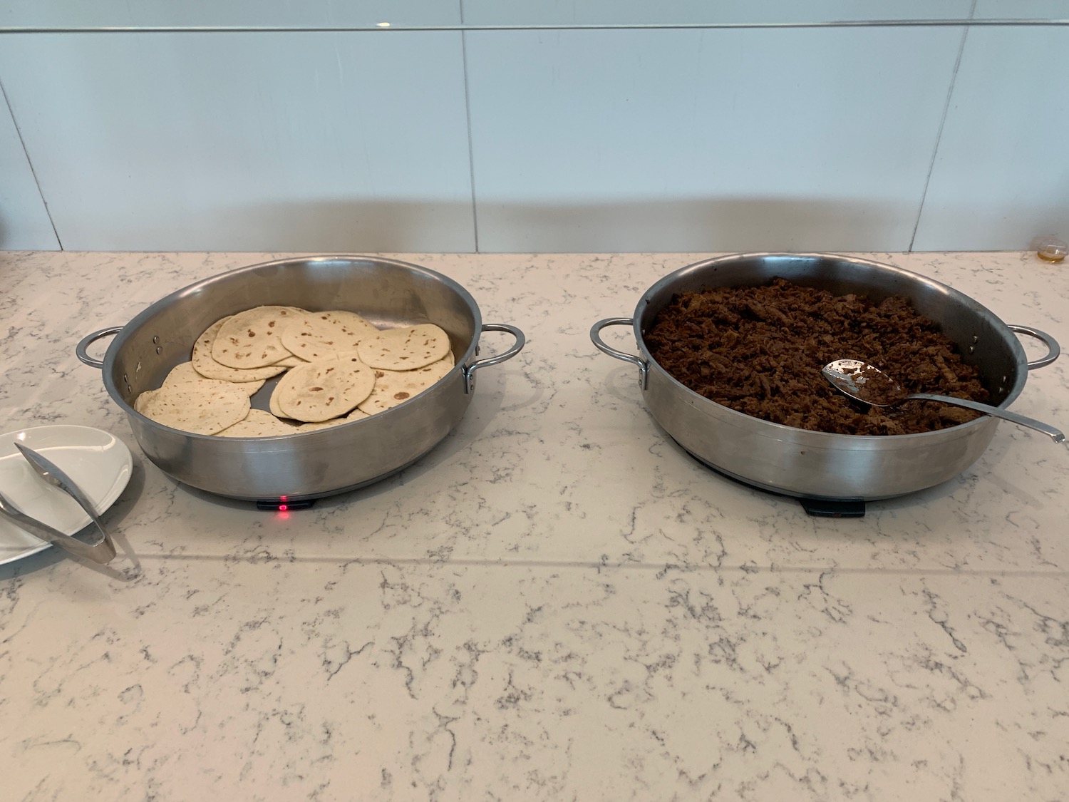 a bowl of food and a bowl of tortilla on a counter