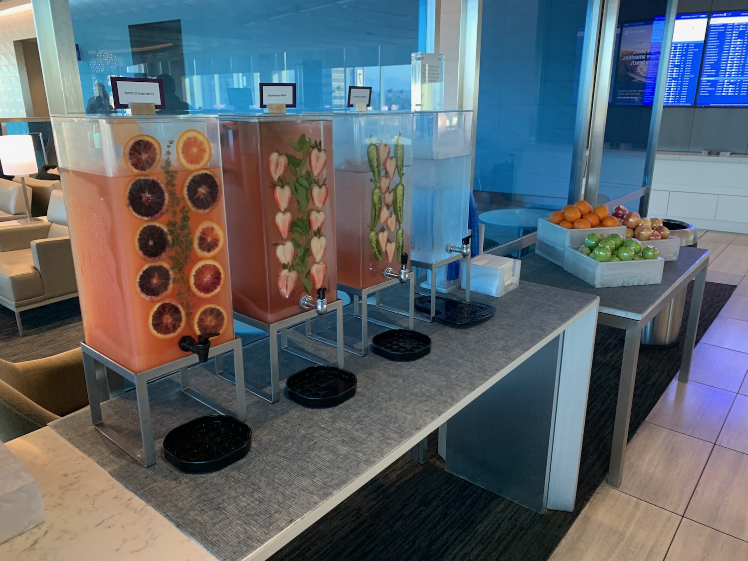 a row of fruit juice dispensers