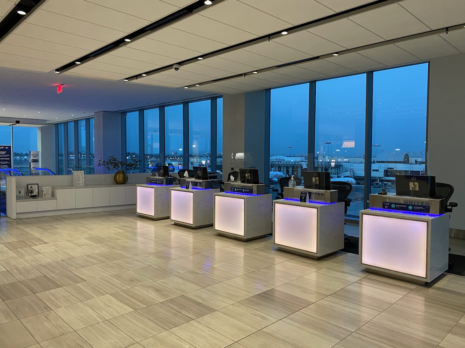 a room with many white tables and windows