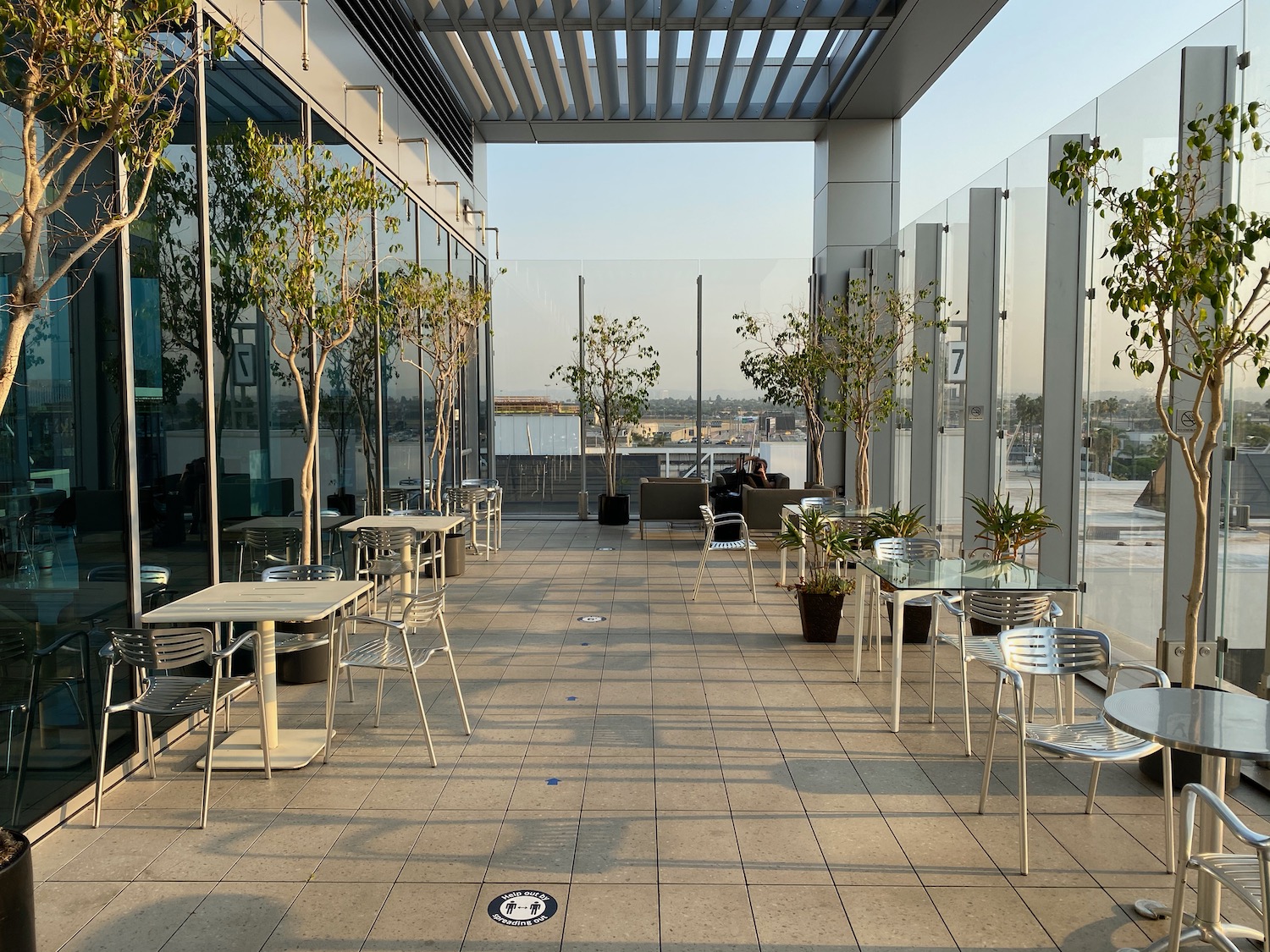 a glass wall with tables and chairs