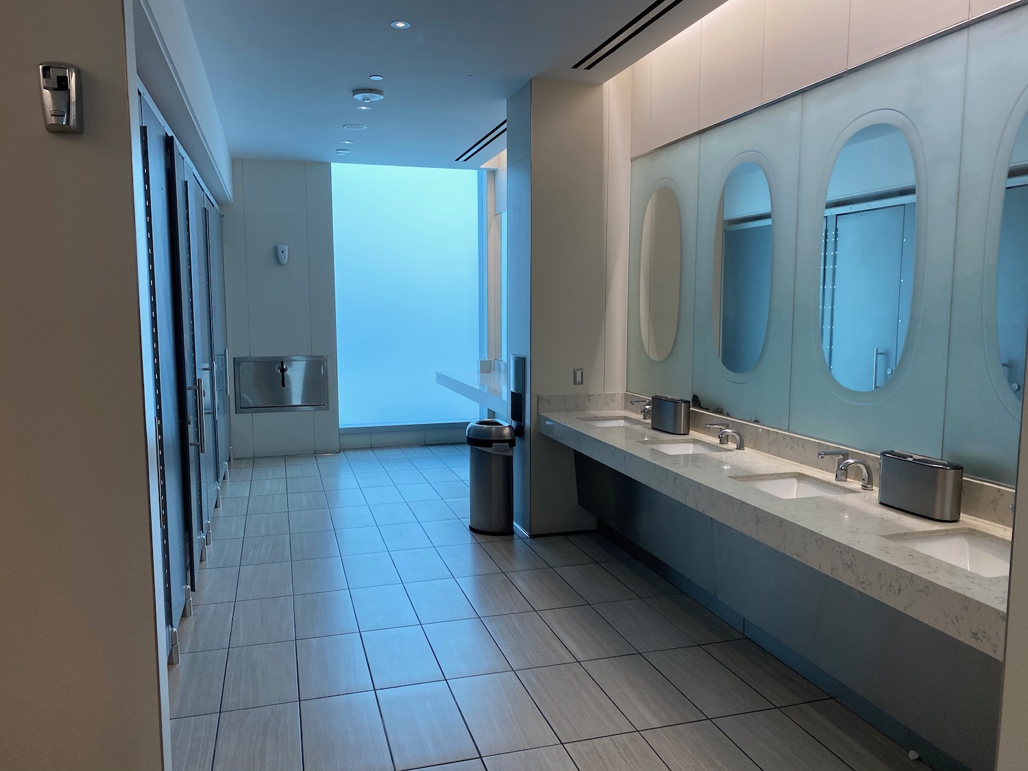 a bathroom with sinks and mirrors